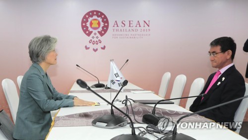 This photo, taken on Aug. 1, 2019, shows Foreign Minister Kang Kyung-wha (L) and her Japanese counterpart, Taro Kono, holding talks on the sidelines of a regional forum in Bangkok. (Yonhap)