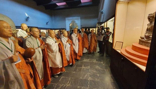 A delegation from South Korea led by Ven. Wonhaeng (3rd from L), chief of the Jogye Order, South Korea's largest Buddhist sect, pays respect to an ascetic Buddha statue displayed at a museum in Lahore, the capital of Punjab province  of Pakistan