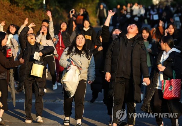This Nov. 14, 2019, file photo shows students celebrating after taking a nationwide college entrance exam in the southwestern city of Gwangju. (Yonhap)