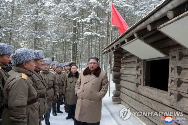 This photo, released by the Korean Central News Agency on Dec. 4, 2019, shows North Korean leader Kim Jong-un (R) visiting a revolutionary battle site on a snow-covered Mount Paekdu, a volcano on the North Korean-Chinese border. (Yonhap)