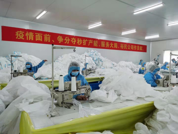 Photo taken on Feb. 8 shows workers busy with production of medical protective supplies in a workshop of a local company in Xiantao, central China’s Hubei Province. (Hou Linliang/People’s Daily)
