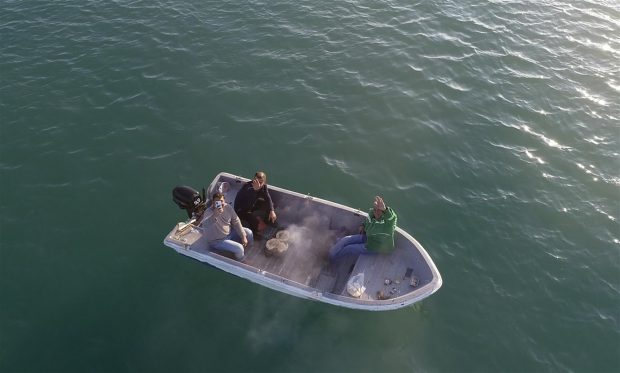 The three men enjoying their boat barbecue (Hurriyet Daily News)