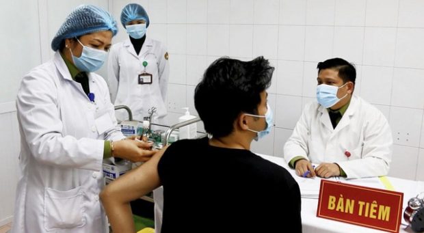 A volunteer is given the NANO COVAX vaccine during a human trial in Vietnam