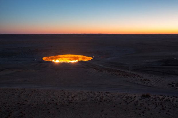 Kourounis George - Darvaza, Turkmenistan Expedition EC0649-13 - Darvaza flaming gas crater at sunrise as seen from a nearby hilltop, overlooking the crater.