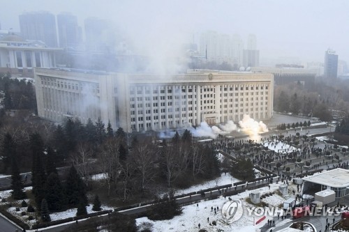 Smoke rises from a government building in Almaty, Kazakhstan's largest city, where protesters in protest against skyrocketing fuel prices broke in. 