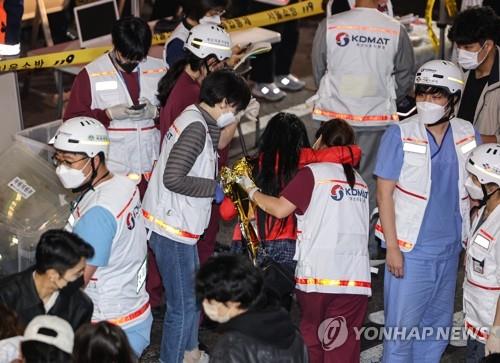 Medical workers attend to victims in Seoul's Itaewon district