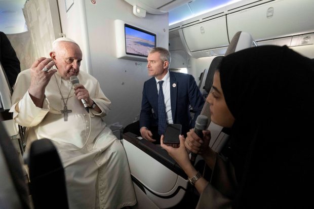 Pope Francis answers the questions of Fatima Khaled Al Najem, Bahrain News Agency reporter, during his flight back to Rome during the flight back to Rome, after his apostolic journey to Bahrain, November 6, 2022. Maurizio Brambatti/Pool via REUTERS