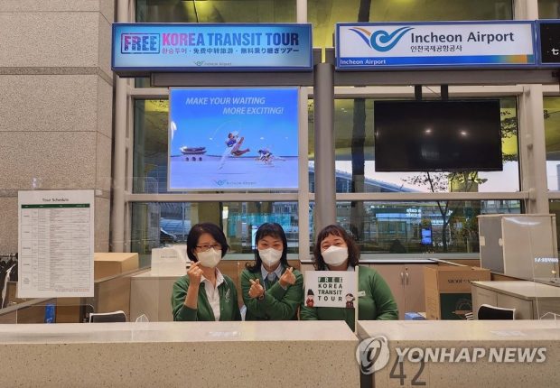Tour guides pose for a photo to mark the reopening of the Free Korea Transit Tour at Incheon International Airport's Terminal 1