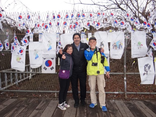 Standing with a Korean family as they visit DMZ. I loved their optimism, especially when they shared the Korean finger heart formed by slightly overlapping the thumb and index finger into a heart shape.
